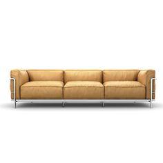 a brown leather couch with chrome legs on a white background and an empty wall behind it