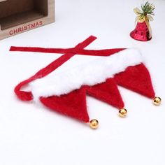 a red and white christmas decoration with bells