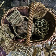 a basket filled with lots of different types of woven material next to shoes and tags