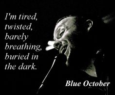 a man singing into a microphone with the words blue october written below his face and in front of him