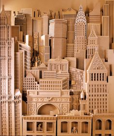 a wooden model of a city with tall buildings