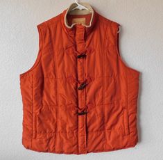 "Orange color quilted vest/windbreaker for women by North Crest Quilted square pattern Mock collar with soft beige lining Zipper, snap button and toggle closure Toggle eye hook orange suede - see photo 2 side pockets Lining Condition is great Dimension - shoulder 17.5\" bust 26\" length 28\"" Winter Orange Sleeveless Vest, Orange Sleeveless Winter Vest, Cotton Lace Tops, Sheer Jacket, Sheer White Blouse, Fashion Network, Quilt Square Patterns, Orange Square, Collar Vest