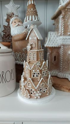 a white shelf topped with christmas decorations and gingerbread houses