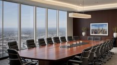 an empty conference room with large windows overlooking the city