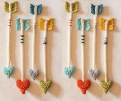 crocheted hearts and arrows are hanging from strings on a white tablecloth background