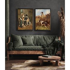 two paintings on the wall above a couch in a room with rugs and furnishing