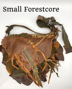 This Forestcore bag is made of brown conditioned leather as the base with green and olive brown accent pieces. The brown leather has many variations of color adding interest and depth to the piece. The main body is leaf shaped with a panel connecting the front to the back. The panel allows for a spacious interior. A leafy lid folds over the body and is secured with a strap and buckle. A leafy green pocket is stitched to the front. I have woven in strips of leather. I used the rough raw edges of Unique Brown Travel Shoulder Bag, Unique Brown Shoulder Bag For Travel, Brown Hobo Bag For Festival, Brown Leather Shoulder Bag For Festivals, Brown Leather Bag For Festival, Handmade Brown Leather Hobo Bag, Hippie Brown Hobo Bag For Festivals, Unique Brown Travel Bags, Handmade Brown Hobo Bag