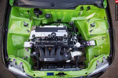 the engine compartment of a green car