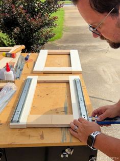 a man is working on an unfinished piece of wood