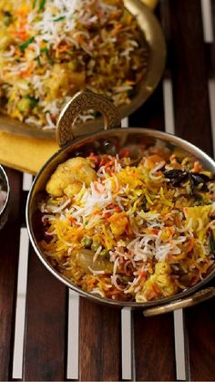 two bowls filled with food sitting on top of a wooden table