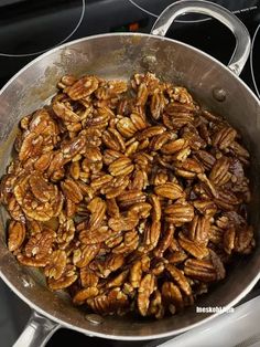 pecans are cooking in a pan on the stove top, ready to be cooked