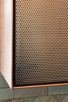 a close up view of a speaker on a brick wall in a room with tile flooring