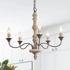 This luxury handmade wooden chandelier with the antique wood finish and rust metal design, gives you a thick sense of history and timeless French country charm. Inspired by traditional European chandelier silhouette, this 5-light French country distressed white wood and antique bronze chandelier features a mango wood and birch wood frame and a series of metal scroll arms, embracing an understated elegance. It is a perfect choice for your dining room, kitchen island, foyer, living room and bedroo Country Ceiling Lights, French Country Chandelier, Country Chandelier, Farmhouse Chandeliers, Rustic Pendant Lighting, Wooden Chandelier, Bronze Chandelier, Farmhouse Chandelier, Wood Chandelier