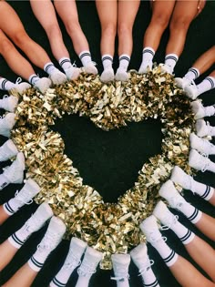 a group of people standing in a circle with their hands together