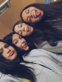 three girls are standing together and smiling for the camera with their heads tilted to the side