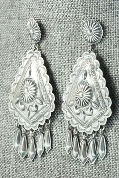 These sterling silver earrings were made by Navajo silversmith Terry Charlie. The back of the earrings are signed T. Charlie and stamped sterling.Length: 2 7/8"Width: 1 3/8"Free shipping on all orders! We ship with USPS and always include tracking. All orders ship within a day of payment.Returns are accepted up to 30 days after you receive your order. Just send us a message. Our shop offers cash back or store credit. The item must be returned in new condition. Southwestern Silver Concho Earrings, Elegant Silver Concho Earrings, Silver Teardrop Concho Earrings, Southwestern Silver Teardrop Earrings, Silver Concho Drop Earrings, Traditional Silver Concho Jewelry, Silver Concho Dangle Earrings, Silver Dangle Earrings With Concho, Native American Jewelry