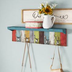 a wooden shelf with two purses hanging from it