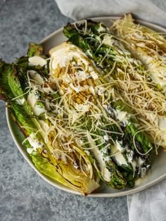 grilled caesar salad with homemade caesar dressing and parmesan cheese drizzled on top