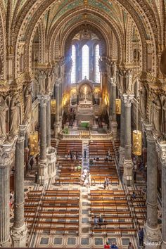 the inside of a church with many pews and arches on both sides of it