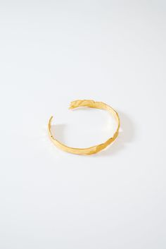 Textured gold finish cuff bracelet Approximate measurements: 1/4" width, 5.75" length Adjustable Yellow Gold Open Cuff Jewelry, Adjustable Open Cuff Gold Jewelry, Minimalist Gold Cuff Bracelet, Gold Open Cuff Bracelet As Gift, Gold Plated Yellow Gold Cuff Bracelet, Yellow Gold Plated Cuff Bracelet, Gold Open Cuff Bracelet For Gift, Gold-tone Tarnish Resistant Cuff Bangle, Tarnish Resistant Gold-tone Cuff Bangle