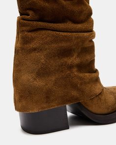 COMPELLING + RUGGED + CONTEMPORARY The PIA boot features a chunky square toe and block heel peeking out from a foldover design with a curved topline. 3.25 inch heel height 12 inch shaft circumference 6.25 inch shaft height Suede upper material Textile lining Synthetic sock Synthetic sole Imported Women's Booties, Football Game Outfit, Steve Madden Store, Apparel Merchandising, Boot Cuffs, Gaming Clothes, Fall Shoes, Chestnut, Block Heels