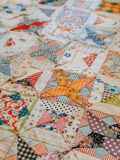 an old quilt with many different colors and patterns on it's edges, including one star