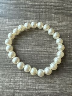 This bracelet is made with cream pearl beads. Note: Colors may vary depending on your monitor Shipping Info: All orders are shipped from Canada and they are sent through Canada Post.  If you would like expedited/faster shipping, it will cost more and you can reach out to me directly and I will give you pricing. Within Canada: Sent regular mail with no tracking and it can take 5-10 business days to arrive. United States: Sent with tracking and it can take 5-13 business days International: Sent In Pearl Bracelet With 8mm Beads, Pearl White Pearl Bracelet With 8mm Beads, Pearl White Bracelets With 8mm Pearl Beads, White Pearl Beaded Bracelets With 8mm Beads, White Pearl Stretch Bracelet With Pearl Charm, Pearl White Round Beaded Bracelets, Classic White Beaded Pearl Bracelet, Cream Pearl Bracelet Gift, Classic White Pearl Stretch Bracelet