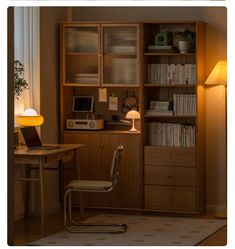 a room with a desk, bookshelf and chair next to a lamp in the corner