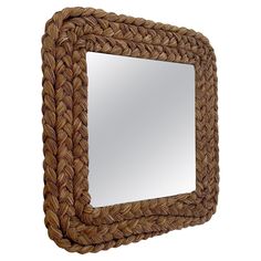 a mirror made out of woven rope on a white background