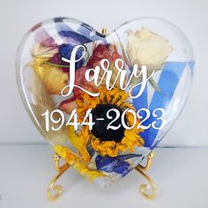 a heart shaped vase with flowers in it and the words marry 1994 - 2013 written on it