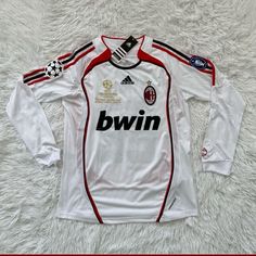 a soccer jersey with the name bwin on it is laying on a white carpet