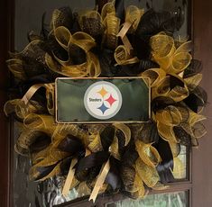 a wreath with the pittsburgh football team on it is hanging in front of a door