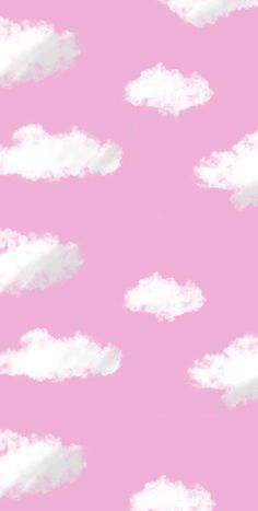 a pink background with white clouds in the sky