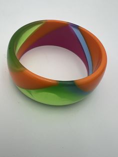 Vintage lucite multicolor swirl bangle bracelet In very good condition, a couple of very minor marks  Measures 2 5/8" diameter  1 1/8" thick 2024 Retro Multicolor Bangle Bracelets, Vintage Multicolor Cuff Bracelet Bangle, Vintage Lucite, Bangle Bracelet, Favorite Jewelry, A Couple, Swirl, Bangle Bracelets, Jewelry Bracelets