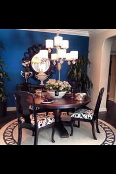 a dining room table with chairs and a chandelier