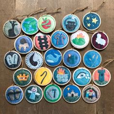 several embroidered badges are arranged in a circle on a wooden surface with twine and string