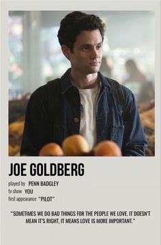 a man standing next to oranges in front of a sign that says joe goldberg