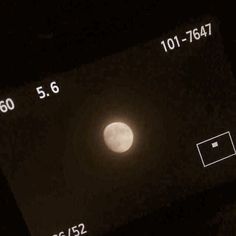 the moon is visible in the night sky with numbers and symbols on it's side