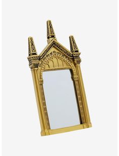 an ornate gold mirror is hanging on the wall