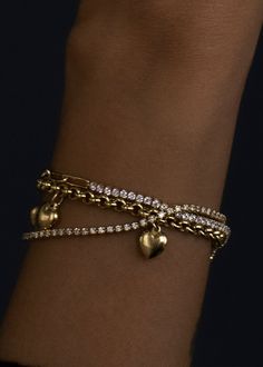 This piece features hollow puffed heart charms on a signature rolo chain bracelet. Wear it as your lucky charm and style with a vintage watch and tennis bracelet. 14k solid gold—alwaysAverage Weight: 5.3gWidth: 3.5mmLobster clasp closureHollow links and charms Classic Everyday Bracelets With Heart Charm, Elegant Everyday Heart Bracelet With Charms, Heart-shaped 14k Gold Charm Bracelet, Classic Bracelets With Charms For Valentine's Day, Classic Charms Bracelet For Valentine's Day, Classic Charm Bracelets For Valentine's Day, Vintage Tarnish-resistant Bracelets, Yellow Gold Heart Bracelet With Charms, Watch And Tennis Bracelet