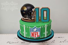 a football helmet is on top of a cake with the number 10 in front of it