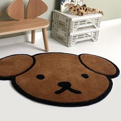 a brown teddy bear rug on the floor in a child's room with toys