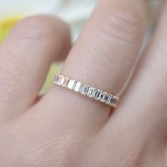 a woman's hand with a diamond ring on it