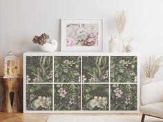 a white cabinet with flowers and plants on it