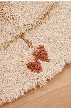 a close up of a rug on the floor with two hearts painted on it,