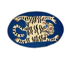 a blue and white rug with a tiger on it's back side, in the shape of a circle