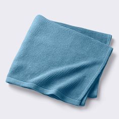 a blue towel folded on top of a white surface