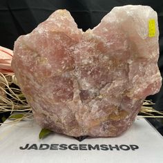 a large pink rock sitting on top of a white box