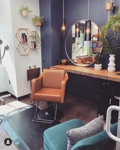 a chair and mirror in a room with blue walls