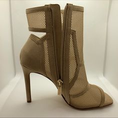 a pair of high heeled shoes with zippers